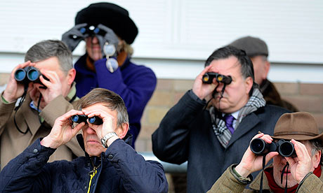 Group of people looking through binoculars